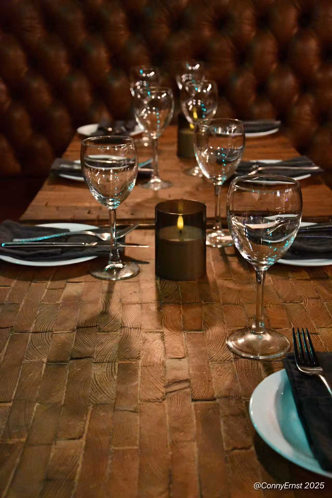 Elegant table setting with wine glasses and teal napkins at a private Icelandic dining experience in Reykjavik