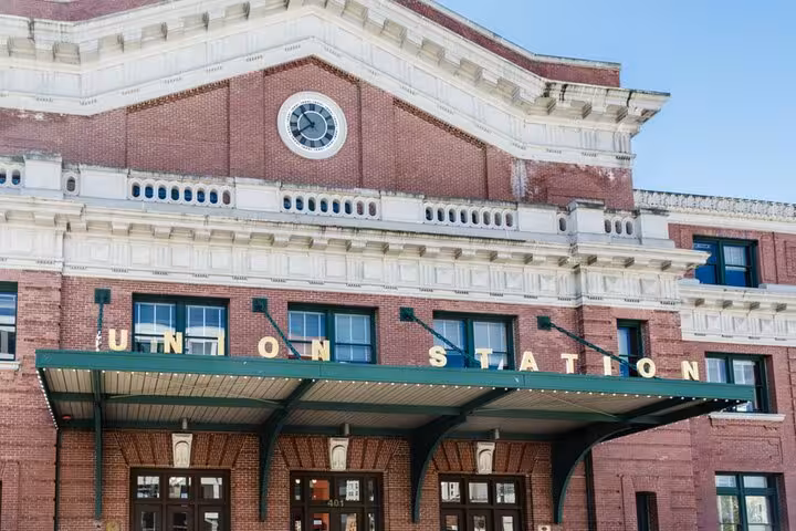Union Station brick building with green marquee sign and clock tower in Seattle