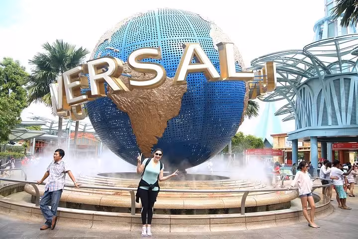 Guests posing by the Universal globe at Universal Studios Singapore Sentosa, entry with admission ticket