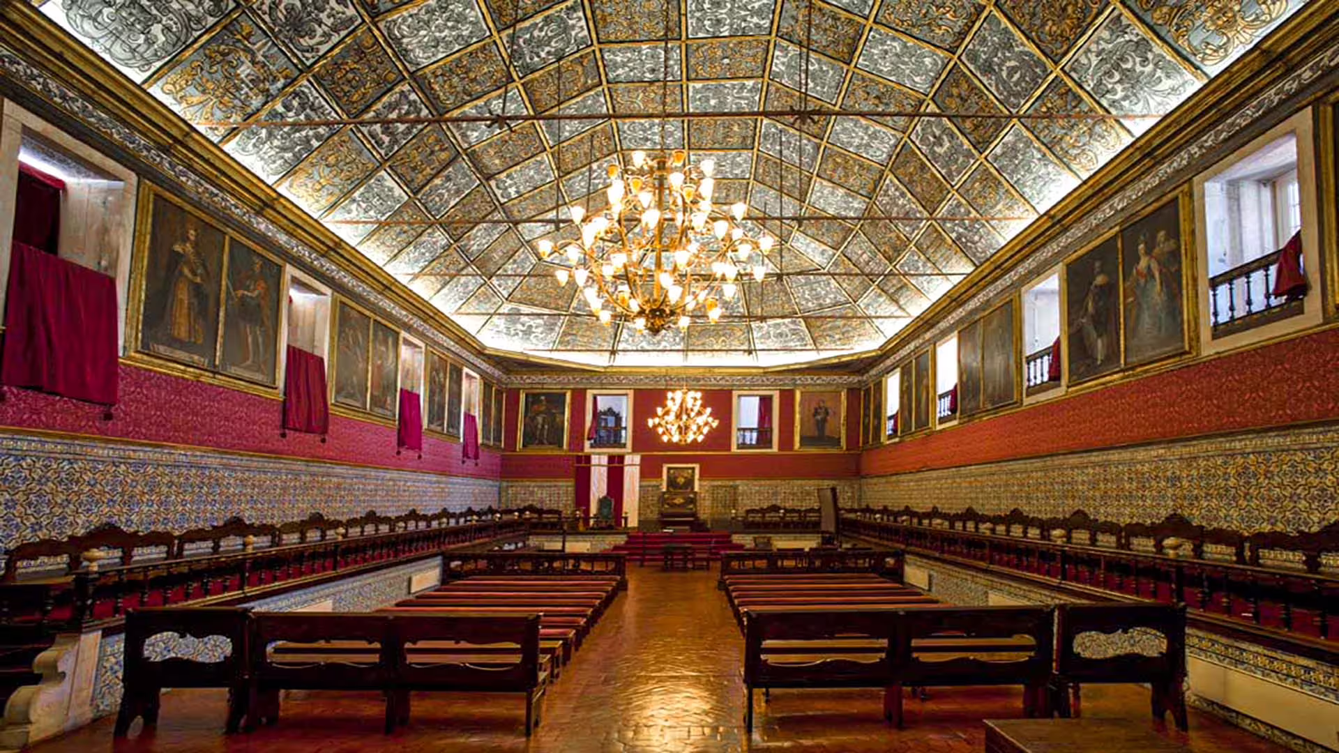 Elegant interior of the University of Coimbra's historical hall with ornate ceiling, ideal for a cultural tour experience.