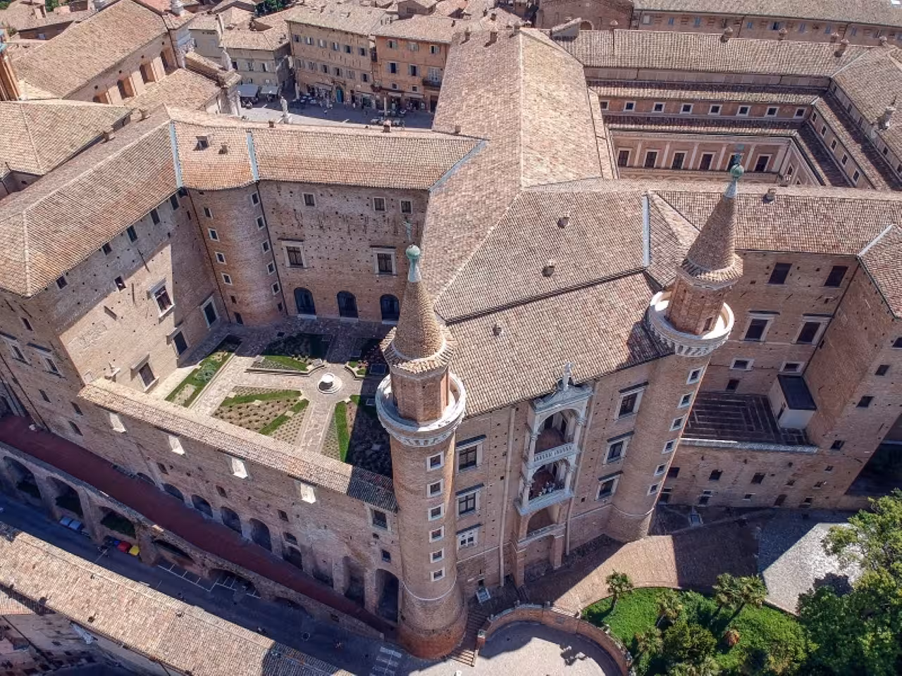Aerial view of Urbino Ducal Palace courtyard, key stop on Renaissance art, history and food tour in Le Marche