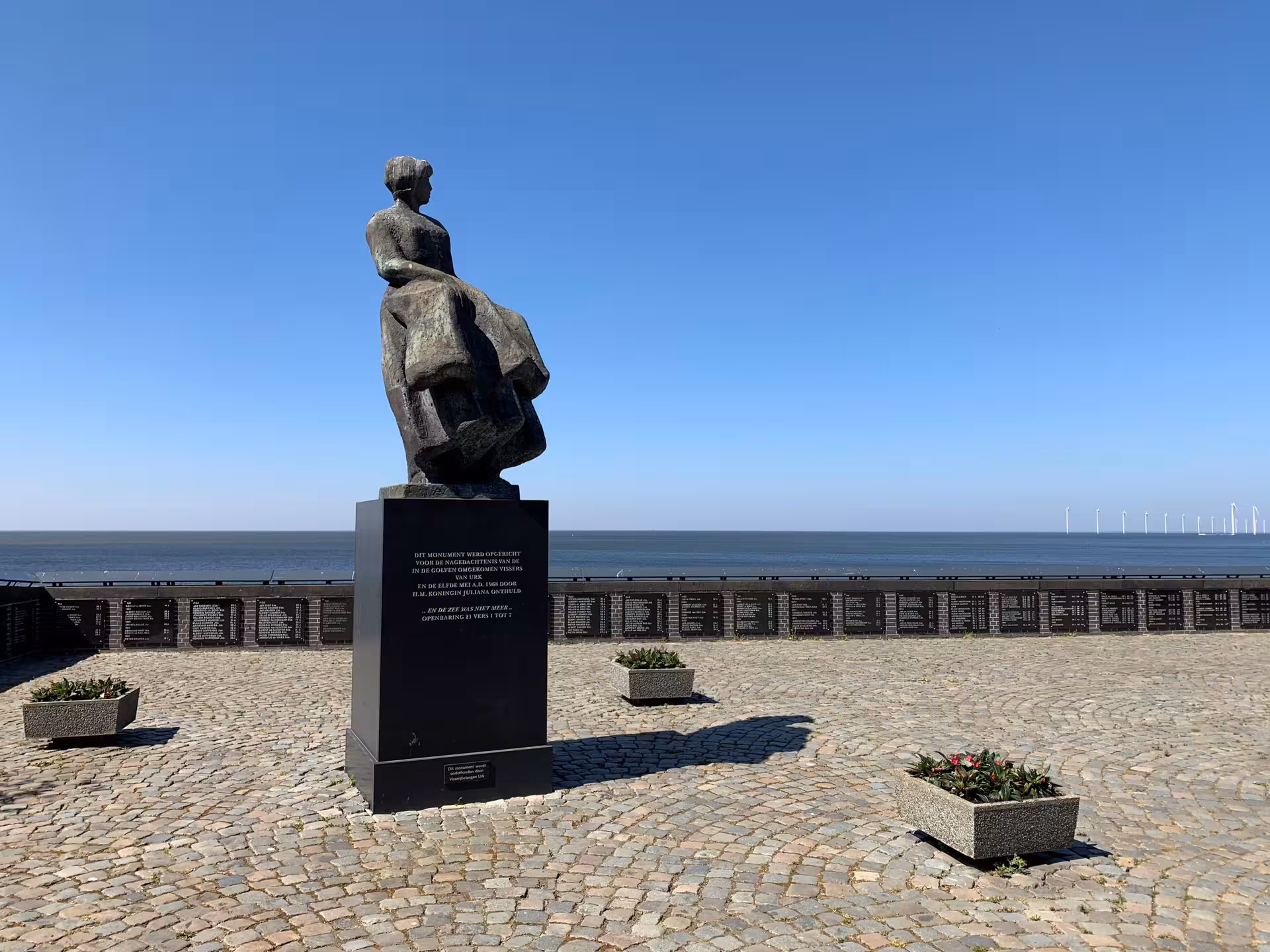 Statue on Urk harbor promenade overlooking the IJsselmeer, stop on private tour from Amsterdam