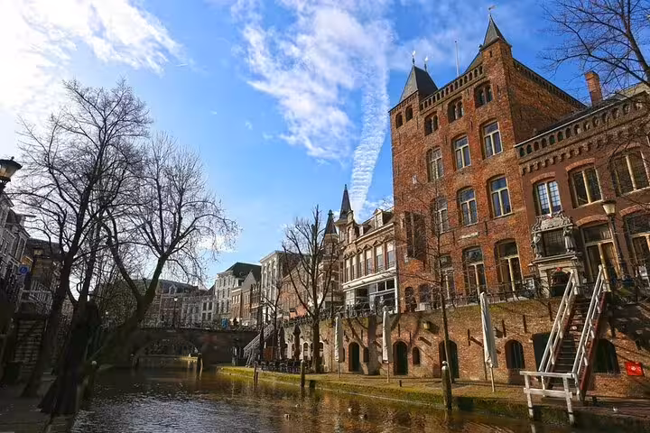 Historic Utrecht canalside brick buildings seen on a private day trip from Amsterdam with a local guide