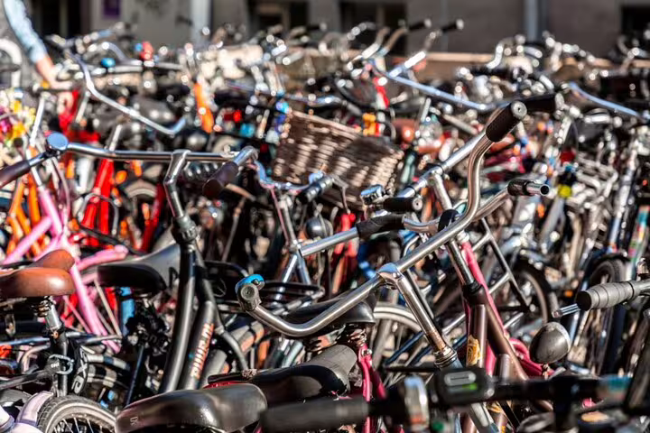 Hundreds of colorful bicycles packed together in a busy Utrecht city bike parking area