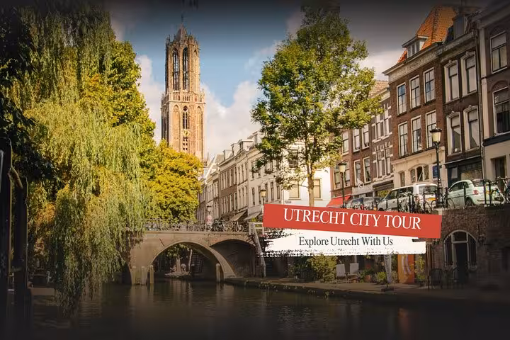 Utrecht city tour view of Dom Tower over canal bridge and historic buildings, ideal for small-group sightseeing