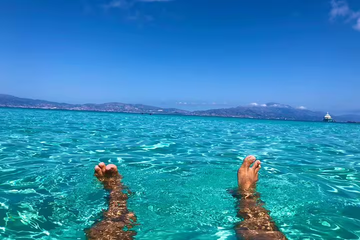 Relaxing in the crystal-clear waters of Vai Beach, a highlight of the private VIP tour.