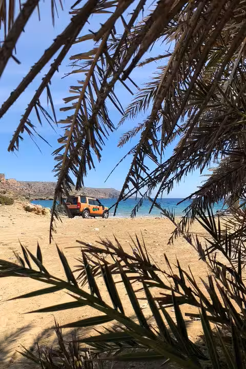 Palm-fringed Vai Beach with scenic ocean view, perfect for a luxury private tour and beach relaxation.