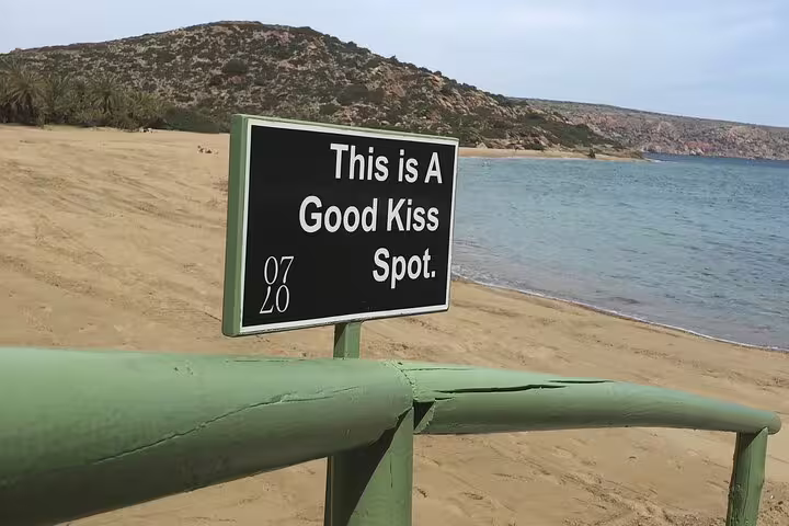 Romantic sign at Vai Beach indicating a perfect spot for couples on a private VIP excursion.