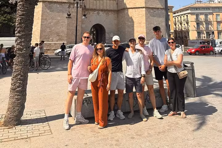 Dutch Valencia bike tour group photo near Serranos Towers, a popular stop on the city cycling route