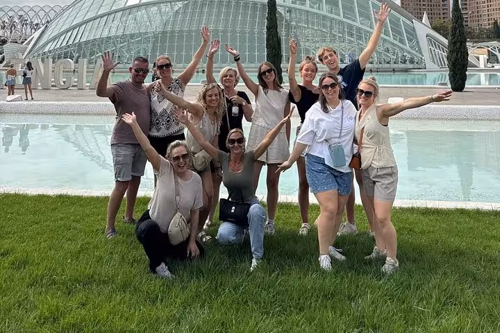 Tour group posing by Valencia City of Arts and Sciences lagoon during all-in-one e-bike ride from old town to beach