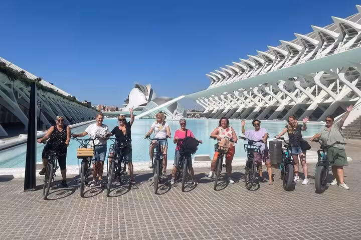 Guided Valencia bike tour group with bicycles at City of Arts and Sciences, starting from Ruzafa