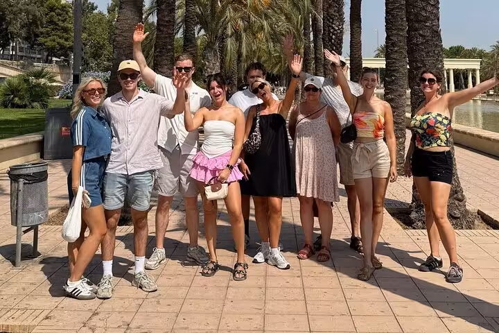 Valencia guided bike tour group in Turia Gardens palms, city highlights ride starting in trendy Ruzafa