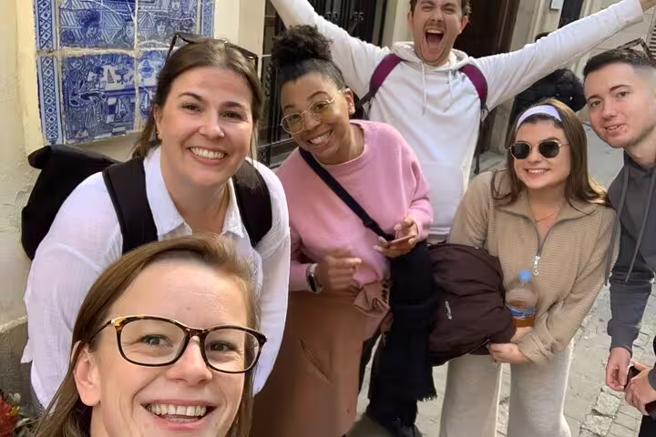 Friends smiling on Valencia Iconic Sights scavenger hunt, exploring old town streets and tile murals