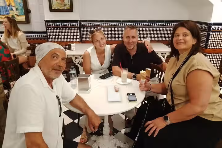 Guests enjoy drinks and tapas at a Valencia bar stop on the gourmet tapas tour by bike or on foot