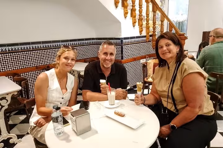 Travelers enjoying horchata and fartons in a classic Valencia café on the gourmet tapas walking tour