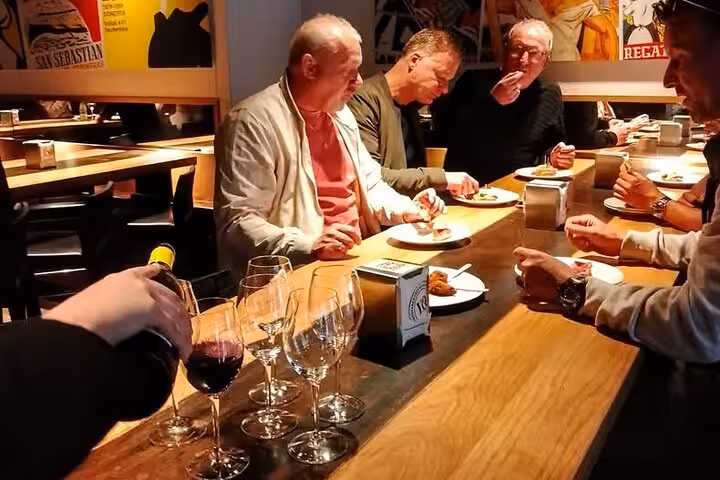 Tasting Spanish tapas with red wine at a Valencia restaurant during the gourmet tapas tour by bike or on foot