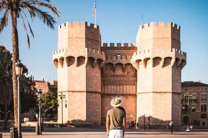 Traveler stands before the historic Torres de Serranos in Valencia, Spain, a highlight of the private half-day tour with local tasting.