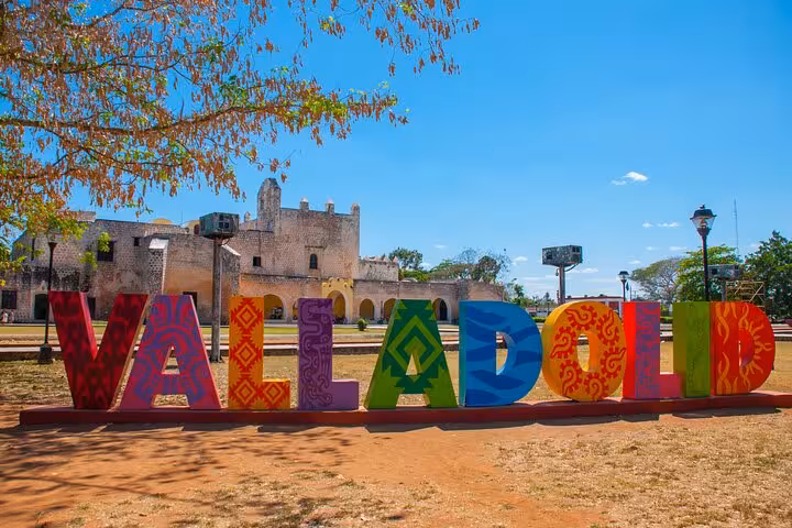 Colorful Valladolid sign with vibrant letters in front of historic colonial church on private Chichen Itza tour