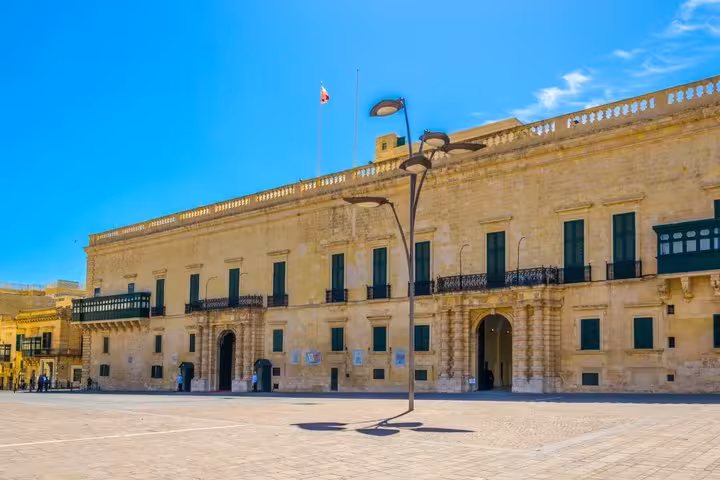Grand Master's Palace facade in St George's Square, Valletta, Malta under blue sky