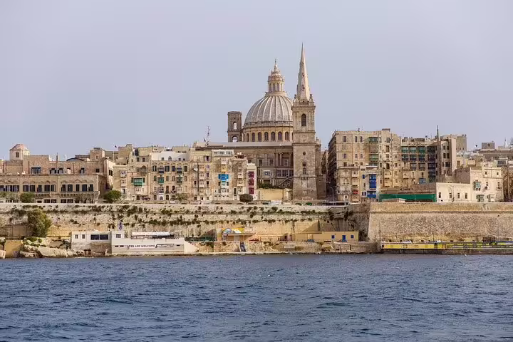 Scenic view of Valletta's historic skyline from the sea, featuring iconic architecture on a full-day Malta sightseeing tour.