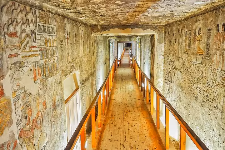 Illuminated tomb corridor with ancient hieroglyphs in Valley of the Kings, Luxor day tour from Hurghada