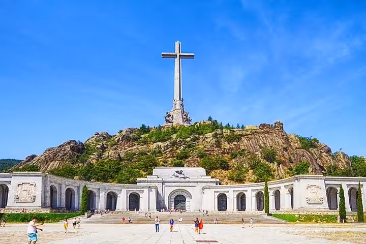 Imposing Valley of the Fallen monument under a bright blue sky, part of the El Escorial and Segovia day trip.