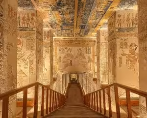 Ornately decorated corridor inside Valley of the Kings tomb with hieroglyphics on walls and ceiling