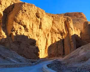 Golden sandstone cliffs and narrow canyon path in the Valley of the Kings, Egypt