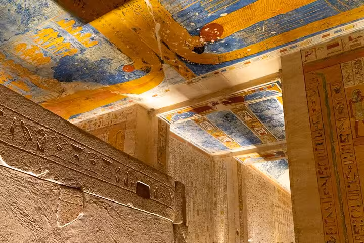 Painted ceiling and hieroglyphs inside Valley of the Kings tomb on full-day Luxor tour from Hurghada