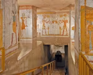 Ancient Egyptian wall paintings and hieroglyphics inside a royal tomb corridor in the Valley of the Kings