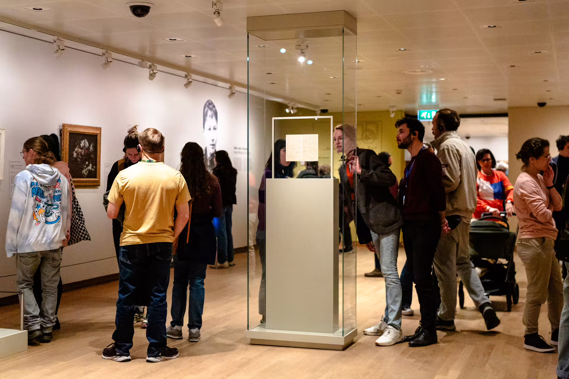 Visitors explore Van Gogh's artwork and letters in a well-lit museum gallery during an engaging guided tour experience.