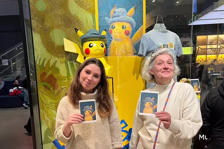Visitors pose by Van Gogh-style museum display in Amsterdam, ideal for Van Gogh Museum tour without tickets