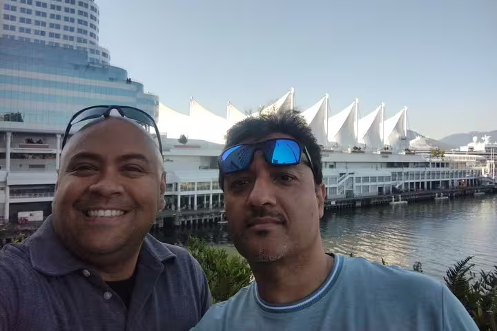 Friends selfie by Canada Place sails on Vancouver waterfront during Gastown scavenger hunt city tour