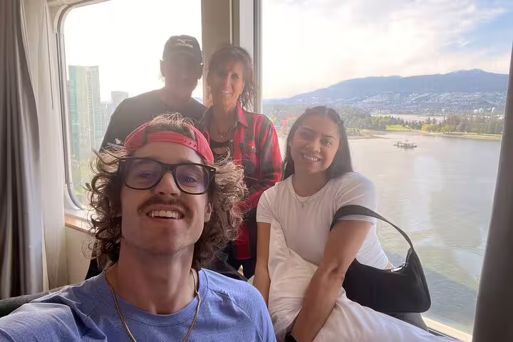 Team photo with Vancouver harbour views, getting ready for a Gastown scavenger hunt and downtown walking tour