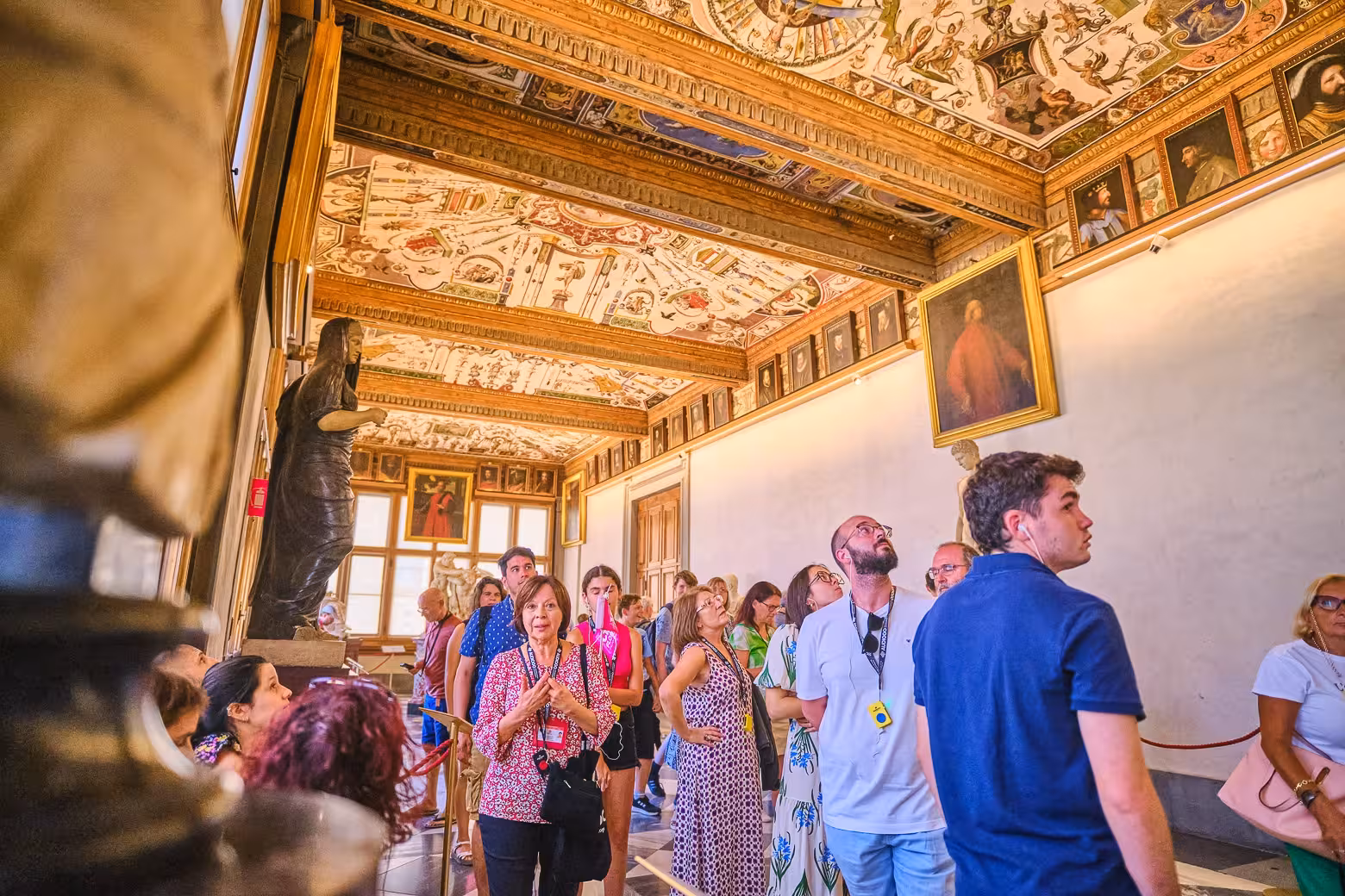 Visitors admire the ornate ceilings and artworks in the historic Vasari Corridor during a private Florence tour.