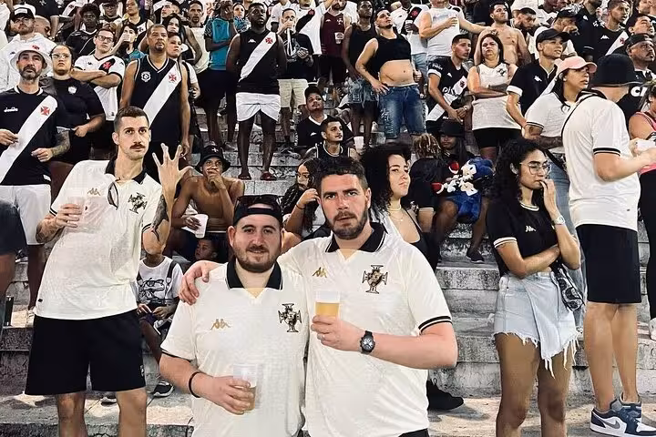 Vasco da Gama fans in Rio stands posing with beers on guided matchday experience at São Januário stadium