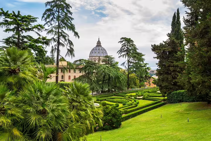 Panoramic view of the Vatican Gardens with manicured hedges and St Peter’s Basilica dome on a Rome private VIP tour