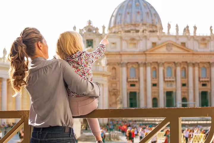 Mother and child enjoying a family-friendly Vatican Museums tour, pointing toward St Peter’s Basilica in Vatican City