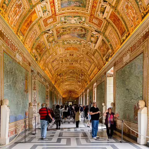 Guests explore the ornate Gallery of Maps in the Vatican Museums during a private Rome tour with VIP skip-the-line access