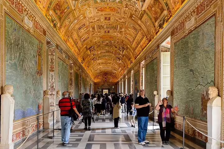 Guided group admiring ornate ceiling and map-lined Gallery of Maps in Vatican Museums on Rome and Vatican City day trip