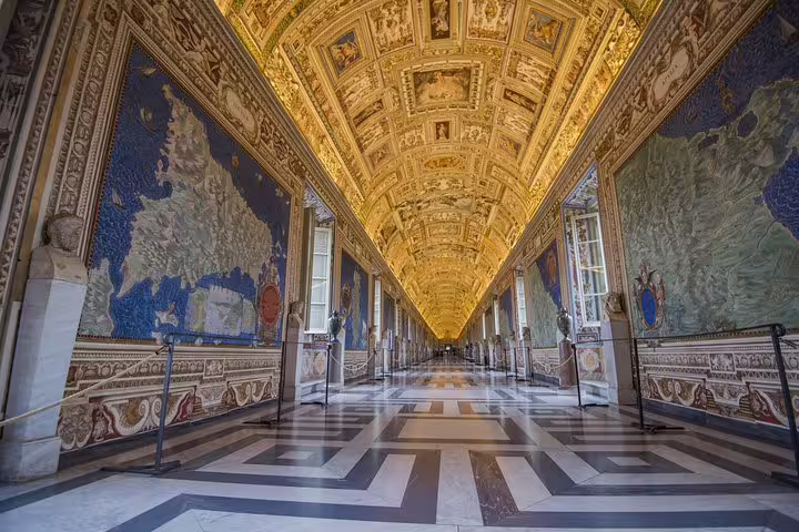 Ornate Gallery of Maps corridor in the Vatican Museums with golden ceiling, visited on a fast track Sistine Chapel group tour