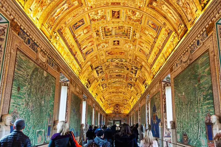 Gallery of Maps corridor in Vatican Museums with ornate gilded ceiling and large map frescoes on walls
