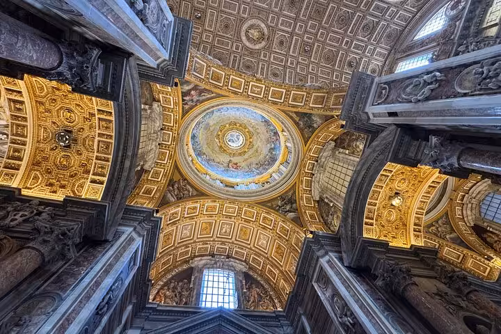 Stunning detailed ceiling dome in Vatican St Peter's Basilica, showcasing intricate artistry.