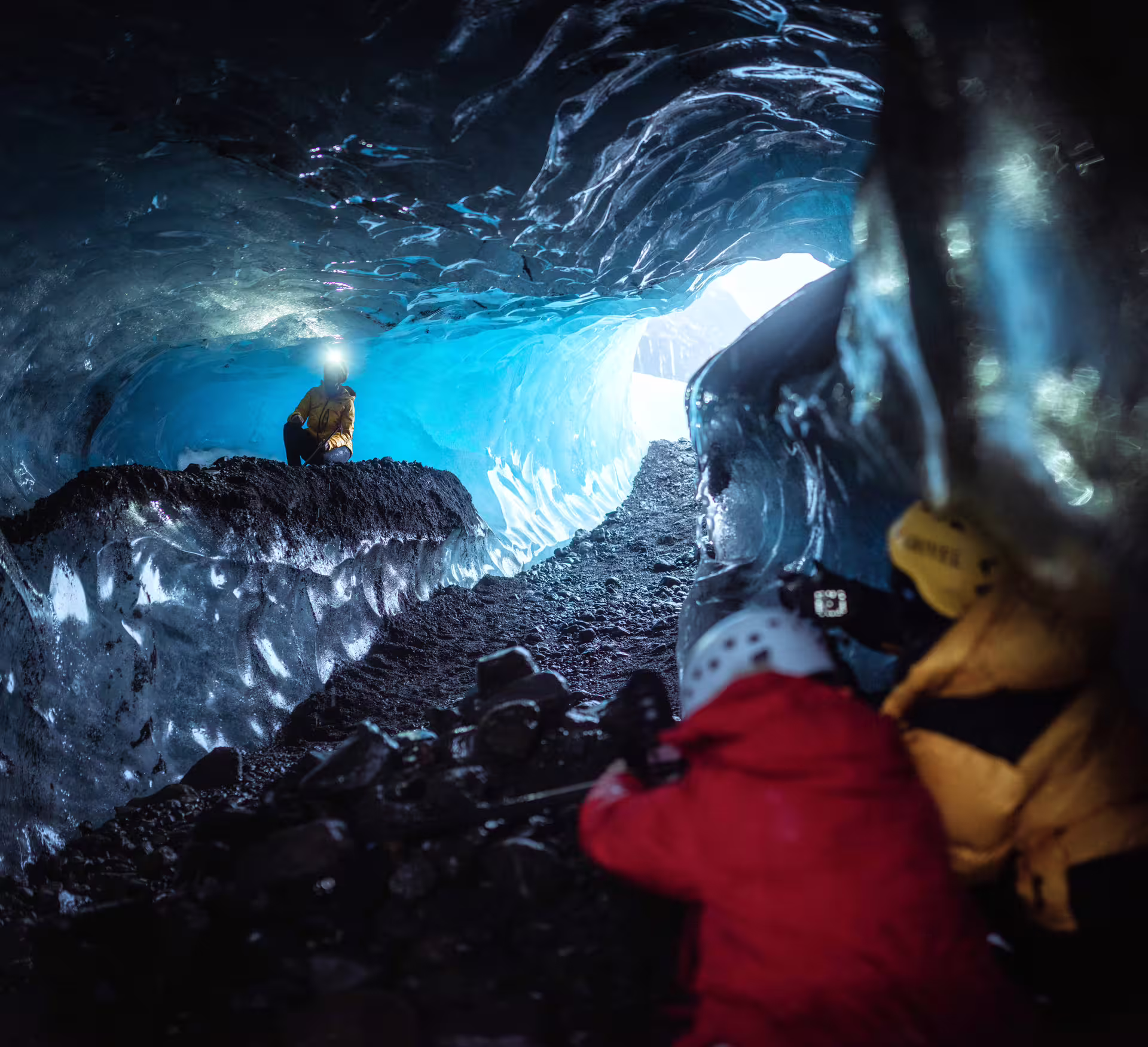 Photographers capturing breathtaking blue ice cave formations in Iceland during an exclusive private glacier photography tour adventure.