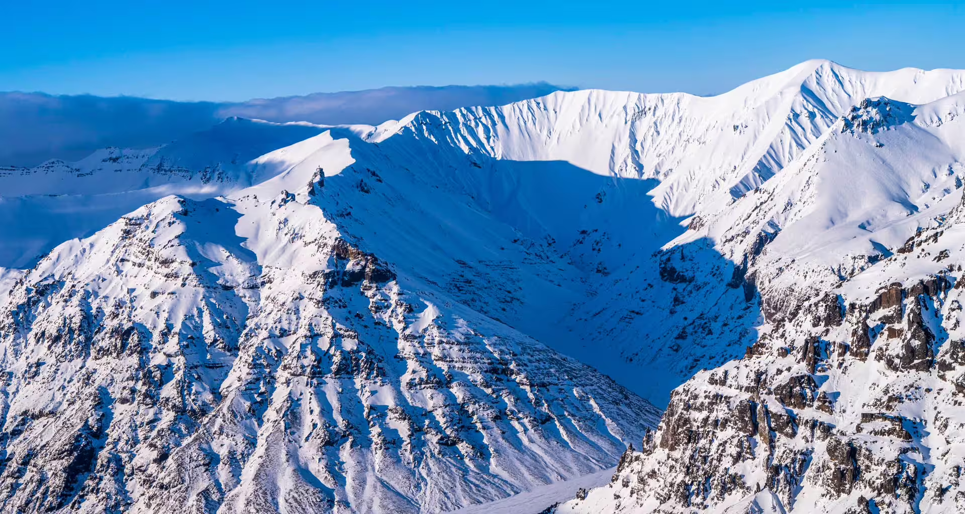 Aerial view of snow-covered Vatnajokull glacier mountains with dramatic peaks and valleys in Iceland