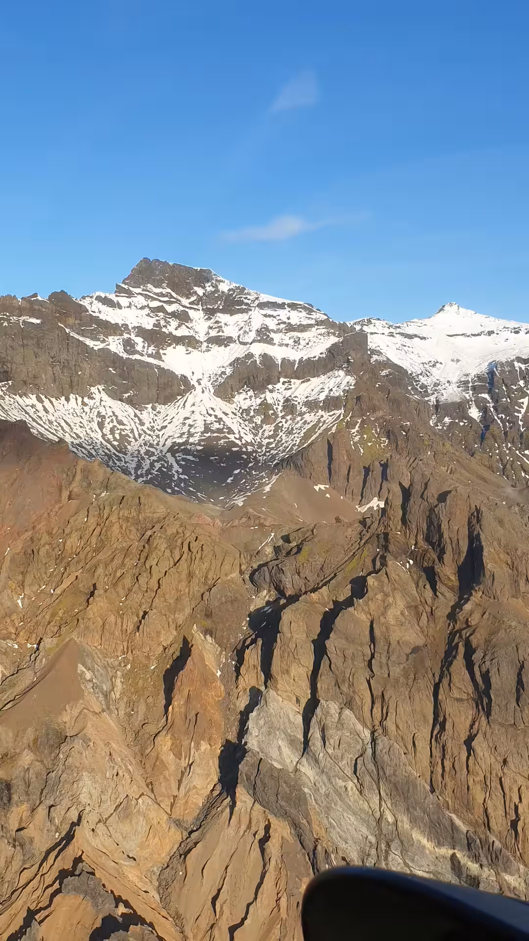 Aerial view of snow-capped rocky mountains and deep canyon valleys at Vatnajokull glacier Iceland
