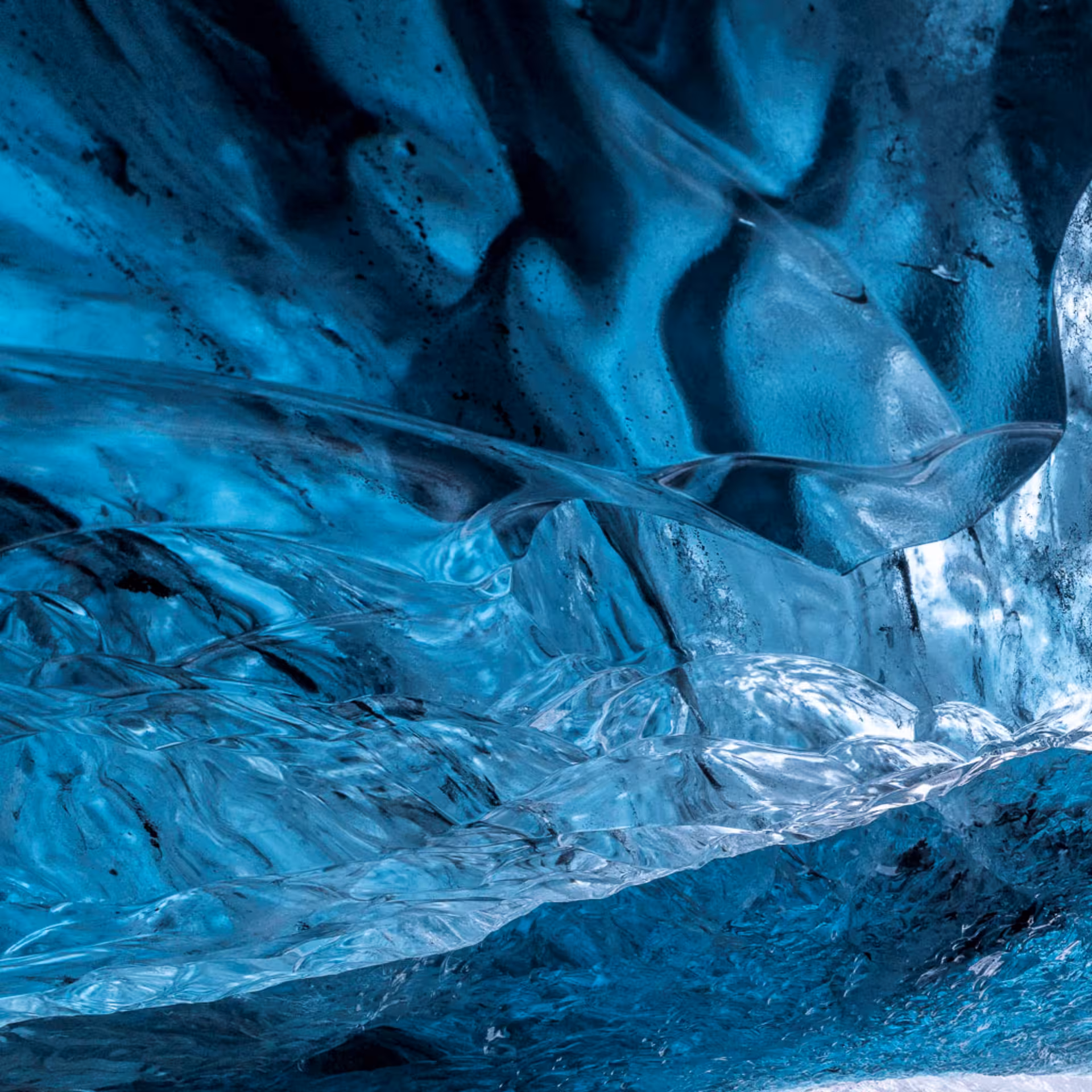 Stunning blue glacial ice cave interior with translucent ice formations at Vatnajokull glacier, Iceland
