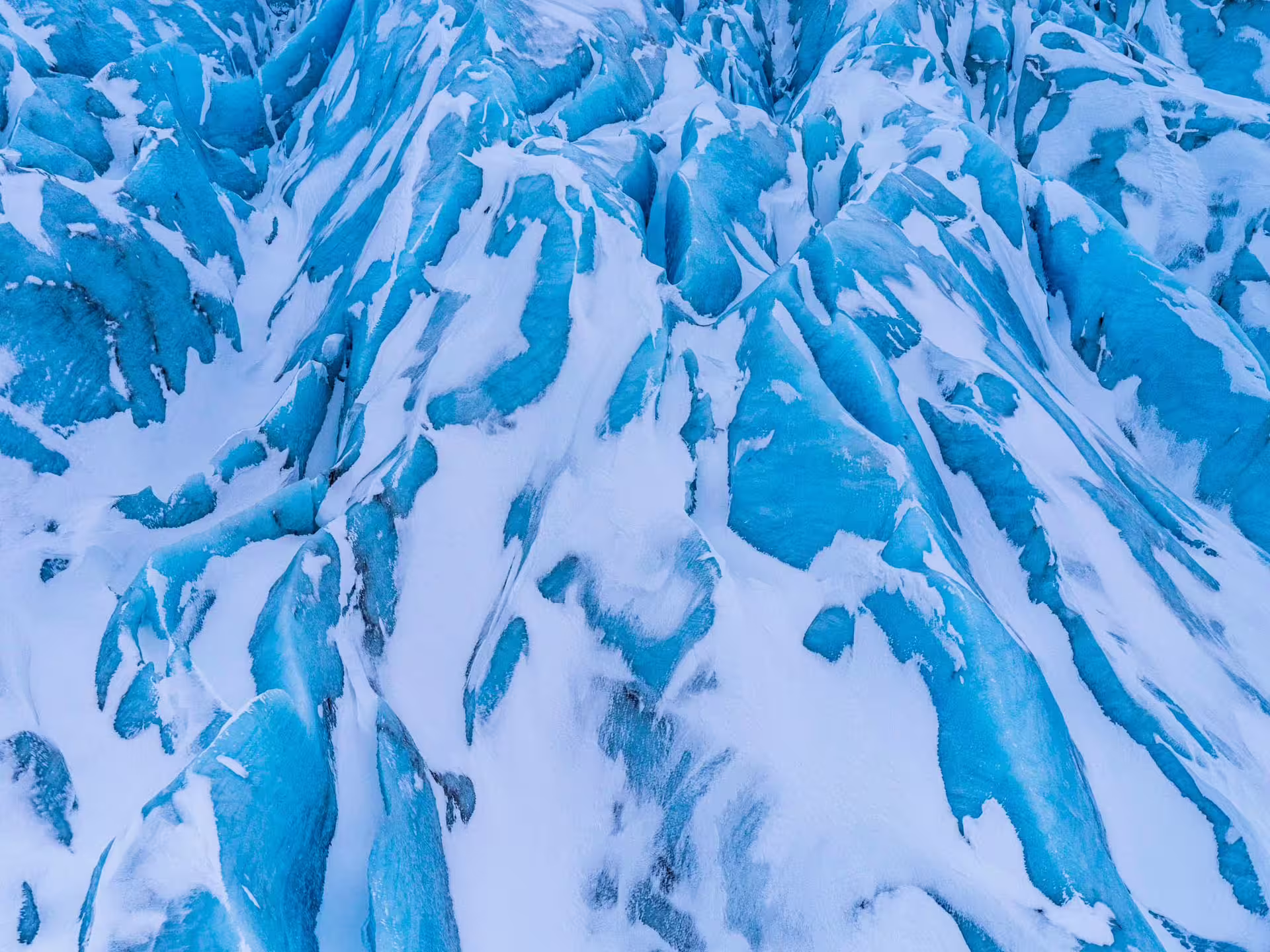 Aerial view of blue glacial ice and snow crevasses on Vatnajokull glacier, Iceland