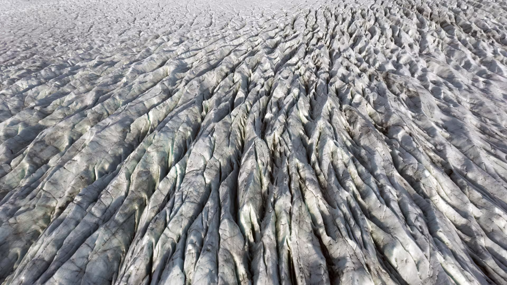 Aerial view of Vatnajokull glacier surface with deep crevasses and ice ridges in Iceland