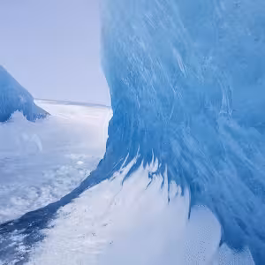 Blue ice cave walls with dramatic frozen formations inside Vatnajokull glacier, Iceland